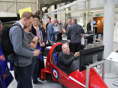 Visitors trying out a hawk cockpit simulator