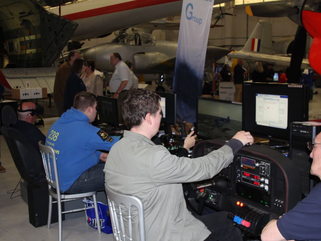A group of simmers trying out various setups, including a realistic cockpit control setup