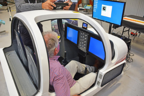 A visitor tries the dual-seat fibreglass cockpit from RC Simulations