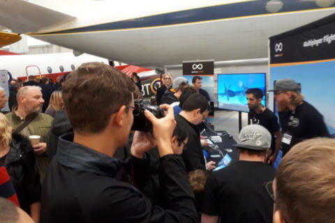 Visitors seeing a different type of sim at the Infinite Flight stand
