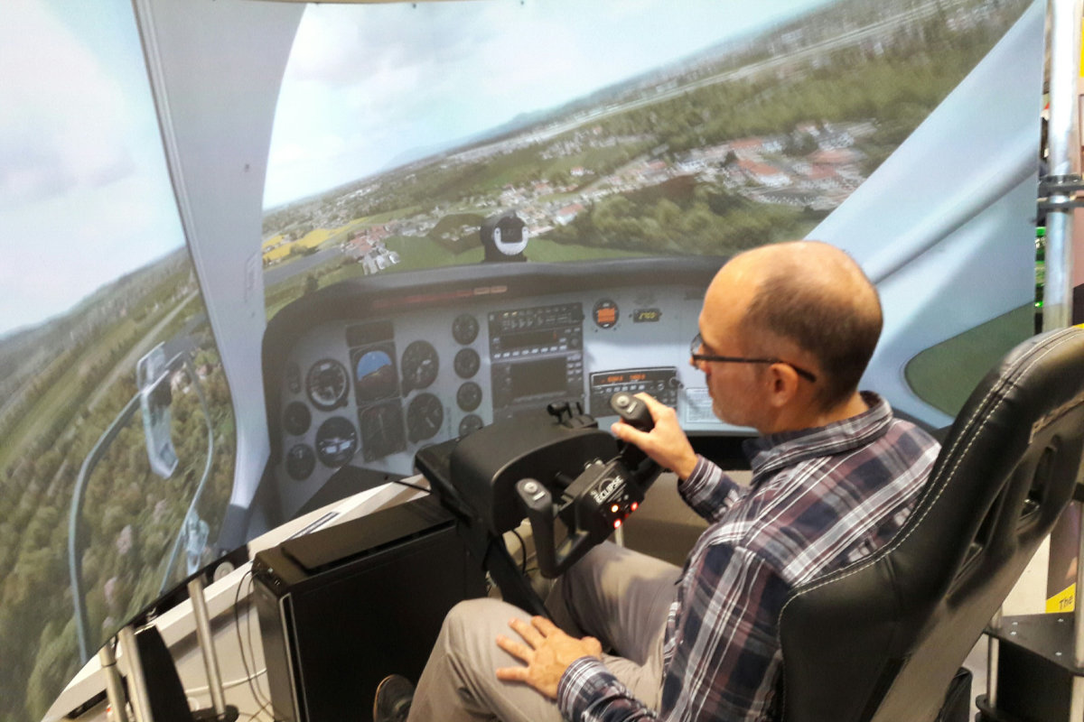 A visitor tries out an immersive sim experience at the Black Widow stand