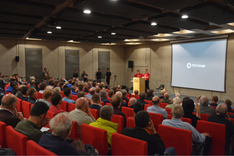 A full auditorium preparing for the presentation by TFDi